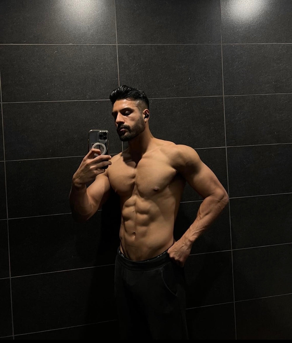 Taran physique portrait in a dark gym
